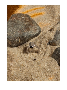 Close-up of S925 silver ring featuring a square black stone and irregular textured band