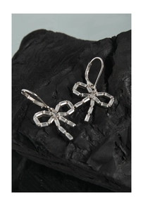 Macro view of S925 sterling silver bow earrings featuring sparkling baguette zircon stones