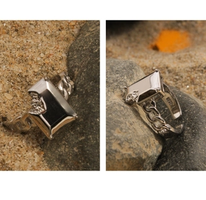Macro detail of S925 sterling silver stamp and black agate stone on Cuban link ring