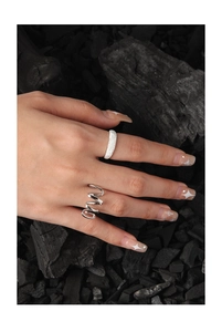 Close-up of S925 sterling silver frosted band and spiral hollow rings on fingers