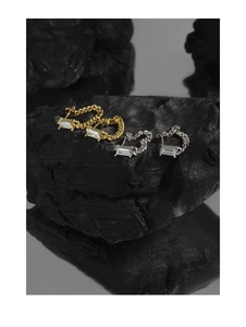 Macro shot of S925 silver chain earrings with square zircon on textured stone