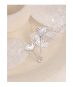 Macro shot of liquid metal heart stud earrings with asymmetric molten silver droplets