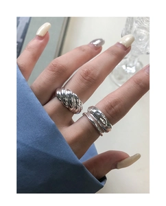 Detail of S925 sterling silver chunky twisted rope ring and polished band on model finger