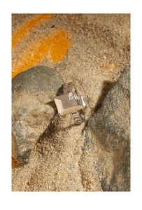 Macro shot of silver rectangular signet ring with embossed detail and chain band