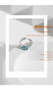 Macro detail of S925 sterling silver ring showing oval blue zircon and purity hallmark