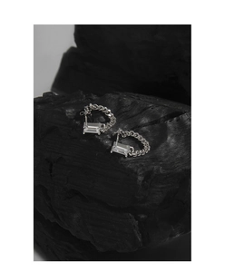 Detailed macro view of S925 sterling silver chain earrings with emerald cut cubic zirconia