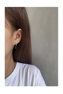 Detail of S925 silver liquid heart earrings with tassel on model for elegant styling