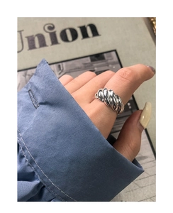 Detail of S925 sterling silver croissant ring with thick textured twisted rope design