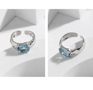 Close-up of S925 silver ring with oval blue zircon and adjustable open band detail