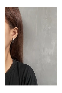 Close-up of S925 silver chain earrings with rectangular zircon on model for a modern look