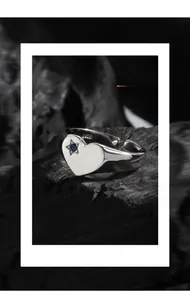 Macro detail of S925 sterling silver heart ring featuring blue zircon and star cutout