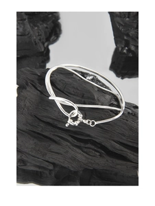 Close-up of S925 sterling silver double-layered snake chain bracelet on black wood