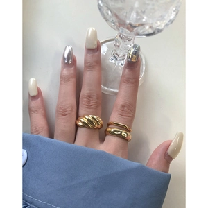 Minimalist gold S925 sterling silver twist ring and layered band on female hand