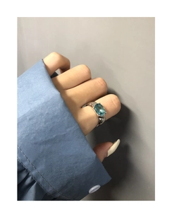 Close-up of S925 sterling silver ring with oval light blue zircon in a four-claw setting