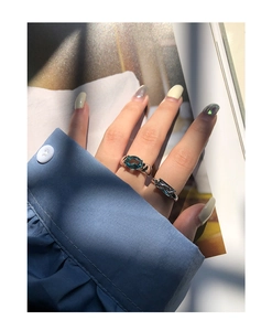 Detail of S925 silver rings with oval blue zircon stone worn on a finger