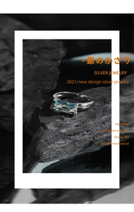 Detailed macro view of S925 sterling silver liquid metal ring with blue zircon gemstone