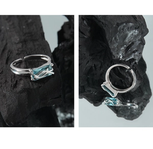 Macro view of S925 sterling silver ring with blue zircon and liquid metal texture