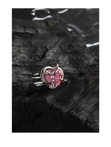 Macro detail of a large pink heart-shaped zircon set in a minimalist S925 silver ring