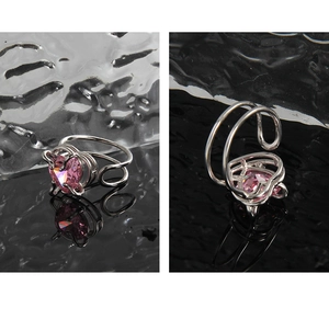 Macro detail of pink heart zircon ring with silver adjustable double band design