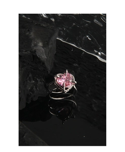 Macro shot of silver S925 heart ring with pink zircon and double-layer band design