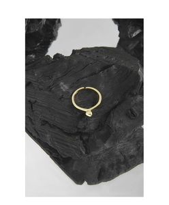 Detailed view of an S925 sterling silver heart ring on a textured black wooden block