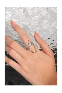 Detail of S925 silver heart padlock charm and pearl chain ring on a female hand