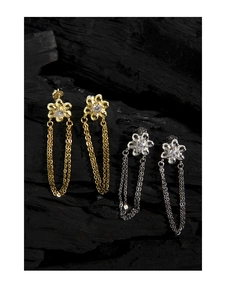 Macro shot of S925 silver flower earrings with tassels in gold and silver plating