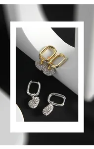 Detail shot of heart-shaped S925 sterling silver earrings with micro-pave zircons