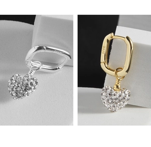 Detailed view of S925 heart earrings with pave cubic zirconia and metal hallmark