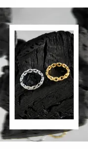 Macro shot of minimalist gold and silver chain rings with pavé cubic zirconia