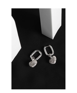 Detailed macro shot of S925 sterling silver heart earrings with sparkling pavé crystals