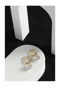 Macro detail of S925 sterling silver heart earrings with white pavé cubic zirconia
