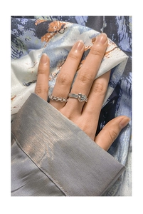 Close-up of S925 silver heart ring and hollow chain stackable ring on model hand