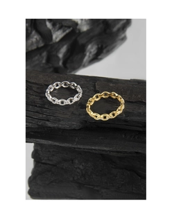 Detailed close-up of gold and silver interlocking chain rings with inlaid zircons