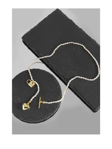 Detail view of S925 silver pearl necklace with gold heart lock and T-bar toggle closure
