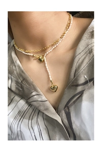 Close-up of double-layer S925 silver necklace with pearls, gold heart, and lock charm