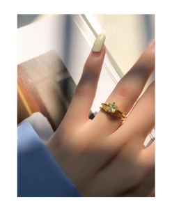 Detailed view of an 18K gold S925 silver ring featuring a green square-cut zircon stone