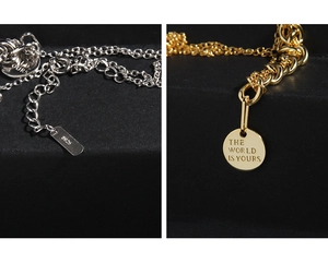 Close-up of S925 sterling silver chain with engraved gold round coin pendant detail