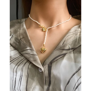 Elegant S925 silver pearl necklace with gold heart lock pendant on a female model