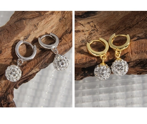 Detail of S925 sterling silver hoop earrings with shimmering pave disco ball pendants