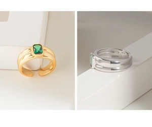 Detail of S925 silver adjustable rings with rectangular green zircon in gold and silver
