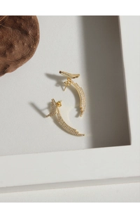Detailed view of gold curved earrings with micro-paved cubic zirconia stones