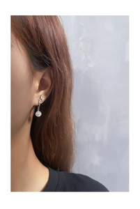 Macro side view of silver S925 lightning stud and micro-paved disco ball hoop earring