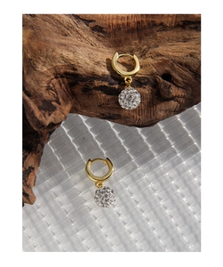 Macro detail of a gold disco ball earring with sparkling pave-set cubic zirconia crystals