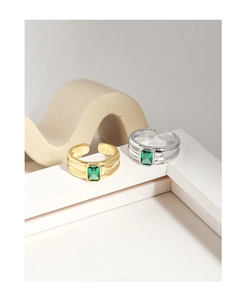 Macro detail of S925 sterling silver rings with emerald cut green zircon and layered bands