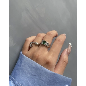 Modern S925 silver ring set featuring emerald cut green zircon on model's hand