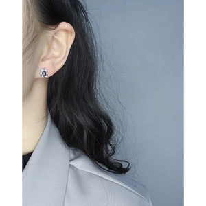 Boucle d'oreille fleur en argent S925 avec zircon noir ovale sur modèle