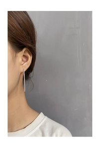 Close-up of S925 sterling silver linear tassel earrings with micro-set white zircons