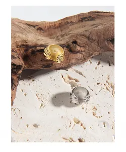 Detail of S925 sterling silver stamp on minimalist wavy gold and silver open rings