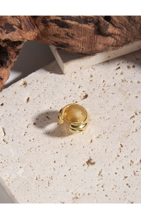 Detailed view of gold plated S925 sterling silver ear cuff with textured wavy surface